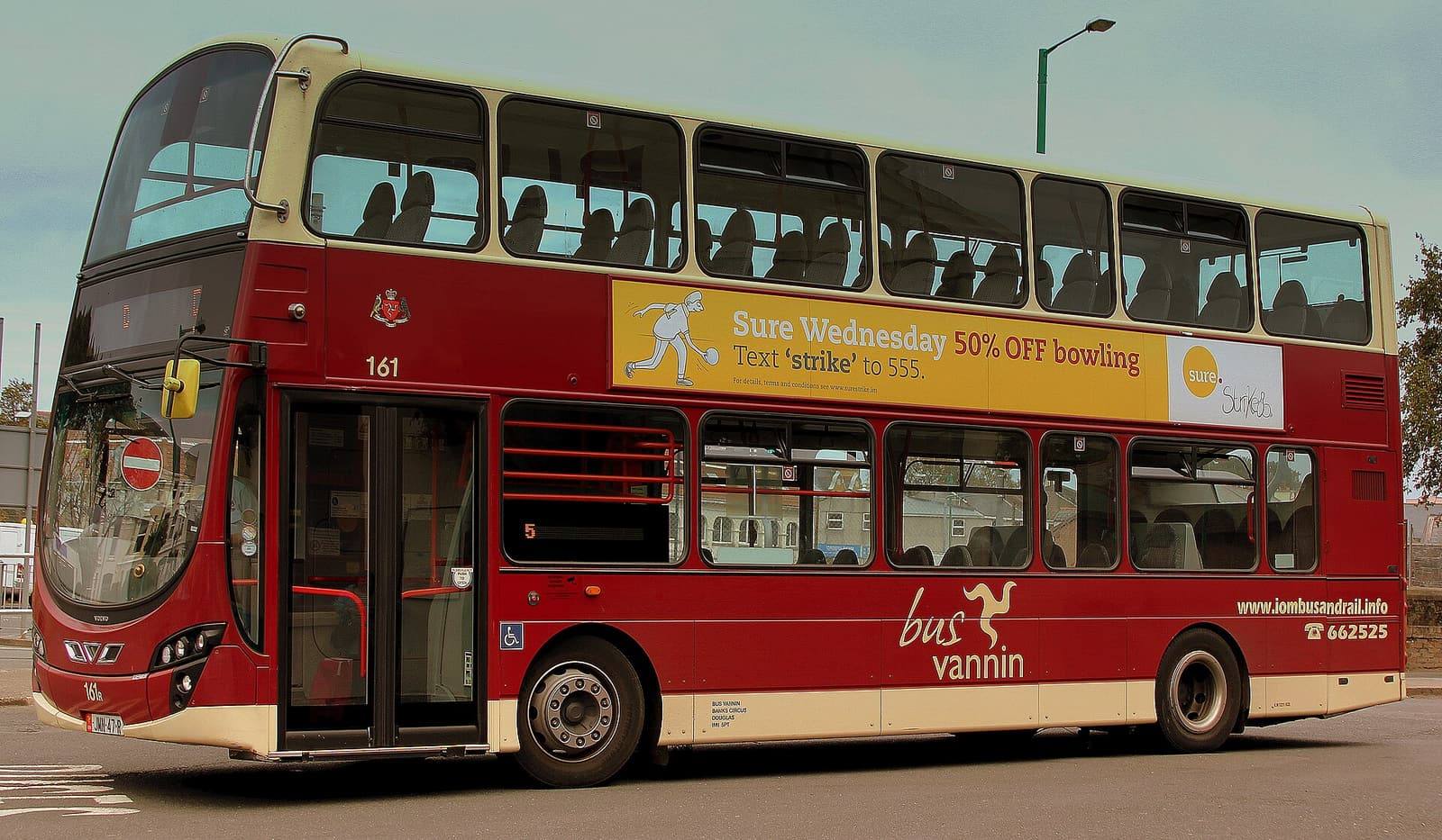 A red and cream Bus Vannin double-decker bus parked at Ramsey bus station.