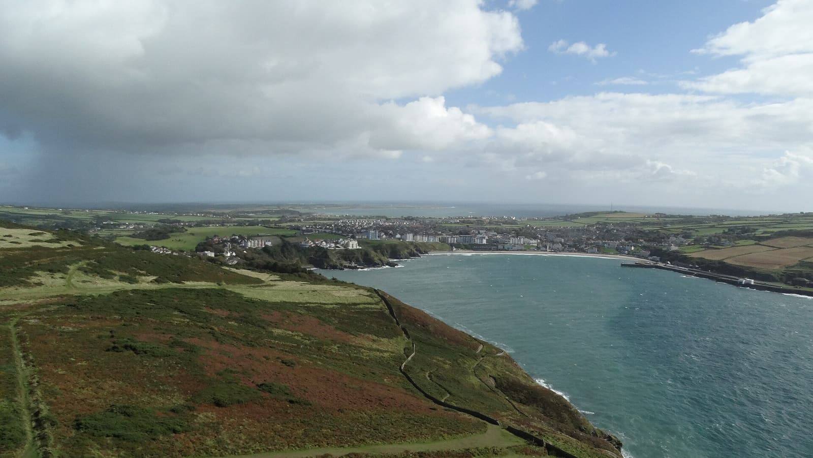 Looking down from Bradda Head over the heather and the long bay of Port Erin towards the south of the island.